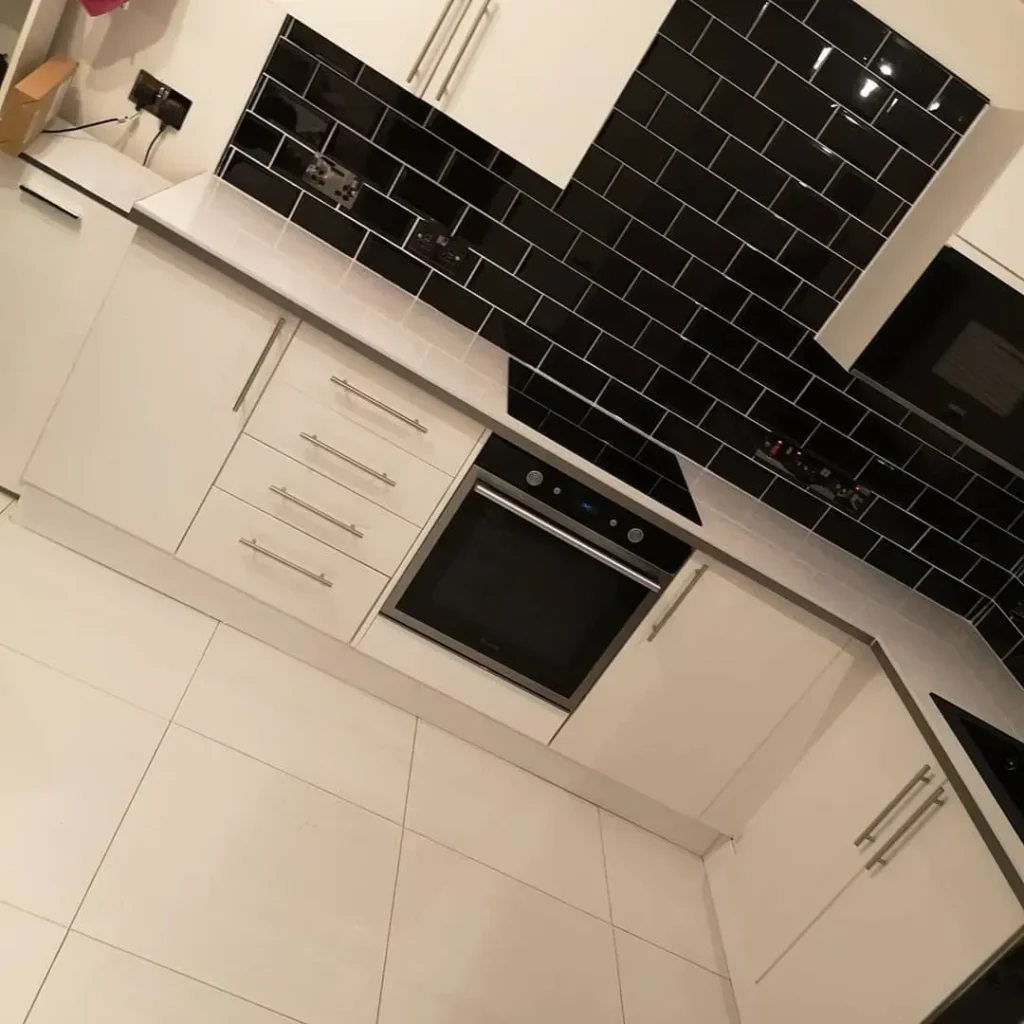 Kitchen installation with black metro tiles - SE6 Services