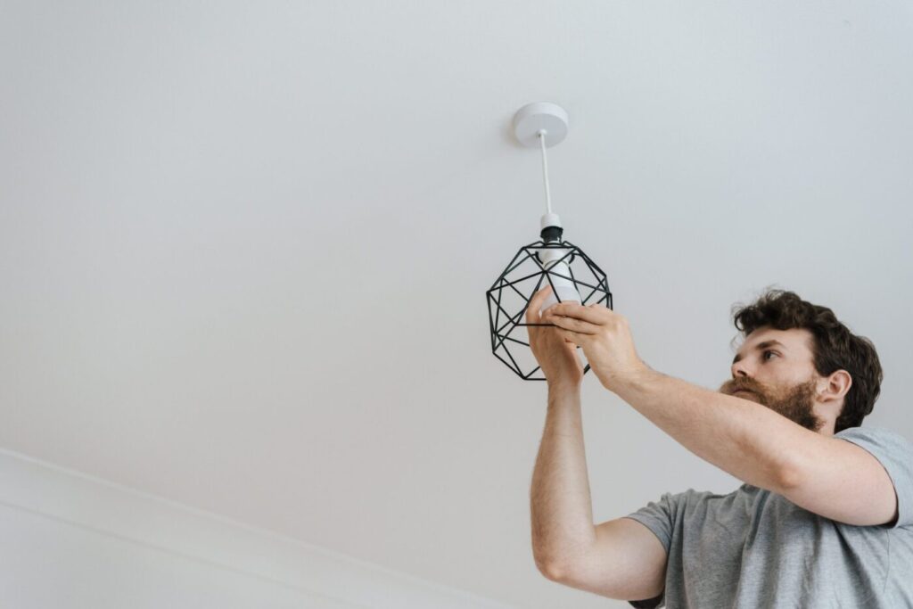Electrician fitting a pendant light