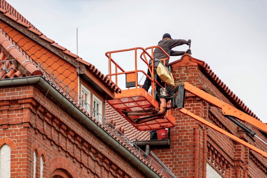 Roofer working on a brick building