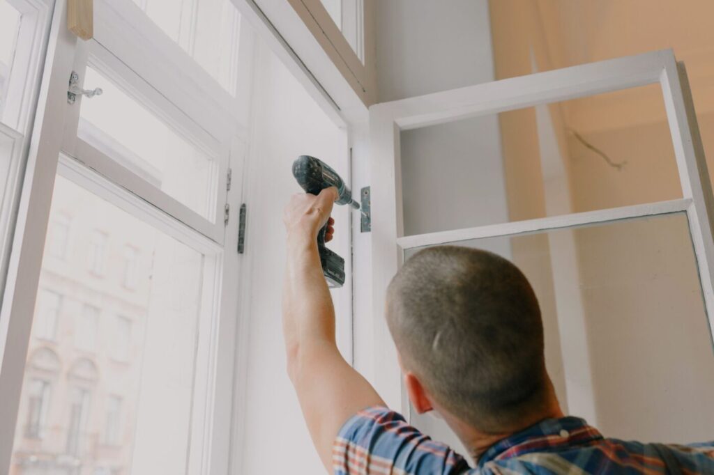 Tradesman fitting a new window