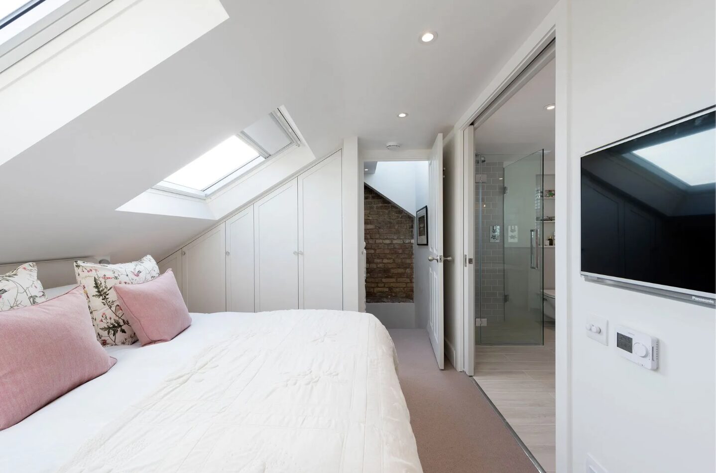 Loft conversion bedroom with skylights